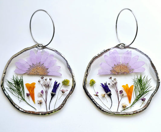 a pair of resin earrings. A combination of fresh herbs from garden and an assortment of pressed and dried flowers 
